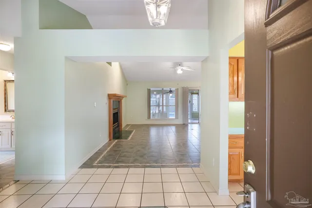 a view of a hallway to rooms and wooden floor