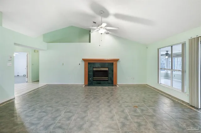 a view of an empty room with a fireplace and a window