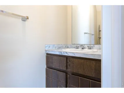a bathroom with a sink vanity and a mirror