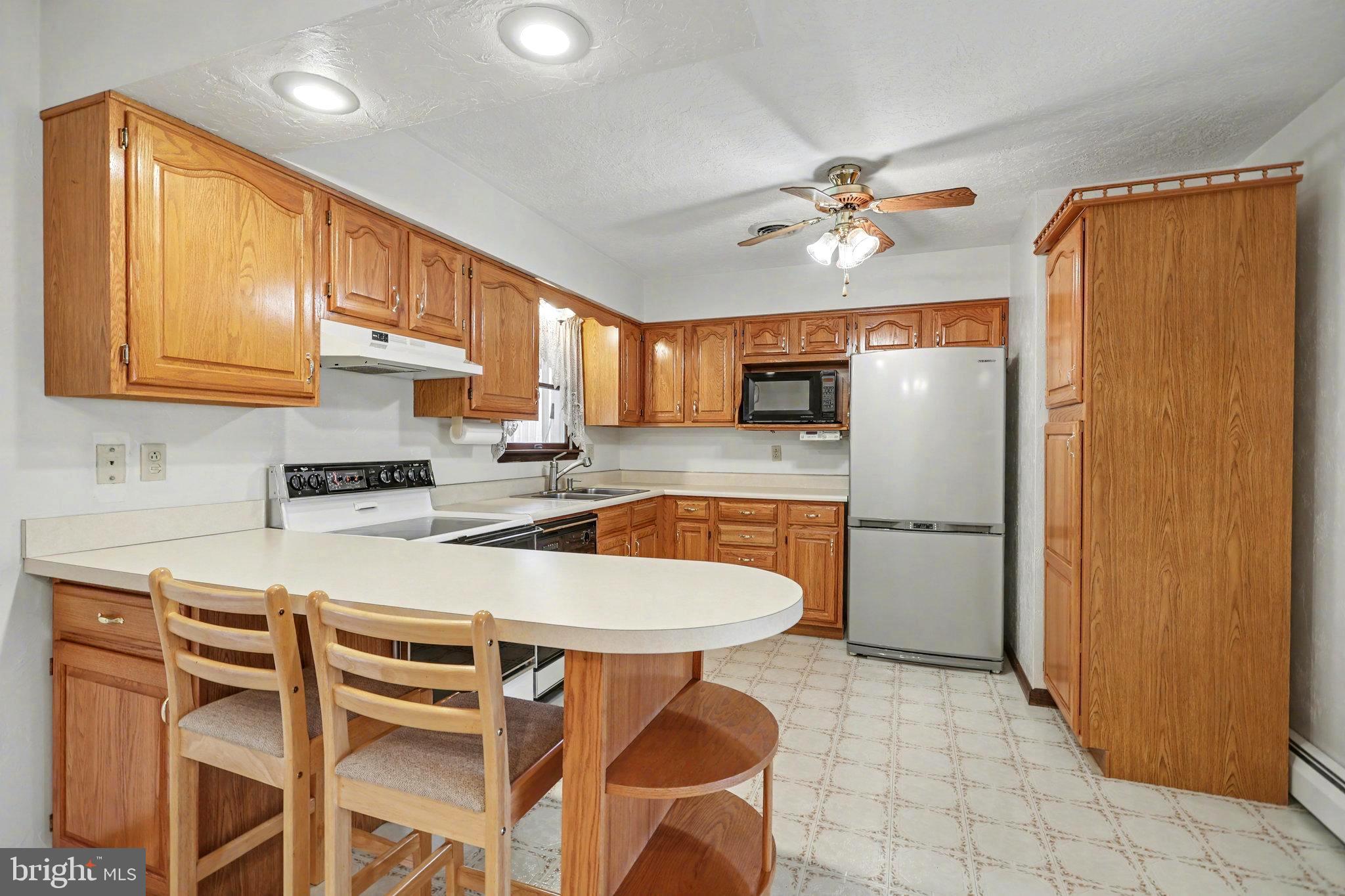 5680 Crone Road Dover, PA 17315 - Photo 15 of 47 a kitchen with stainless steel appliances a table and chairs