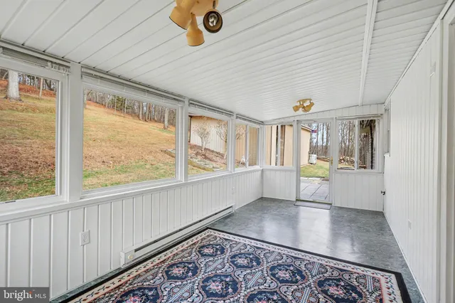 a view of a livingroom with wooden floor and a rug