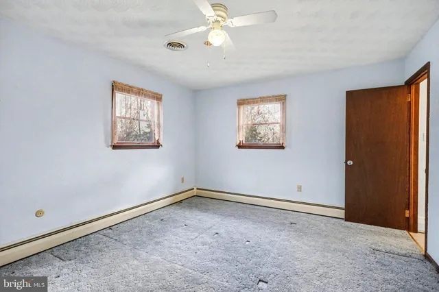 a bedroom with a bed and a potted plant