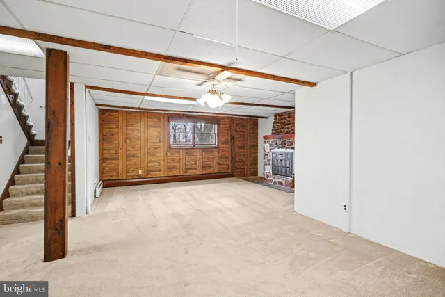 a view of an empty room with a fireplace