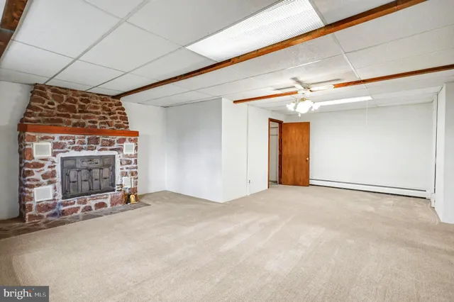 a living room with furniture and a pool table