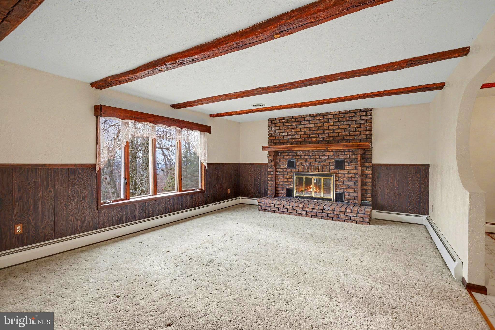 5680 Crone Road Dover, PA 17315 - Photo 10 of 47 a view of an empty room with a fireplace and a window