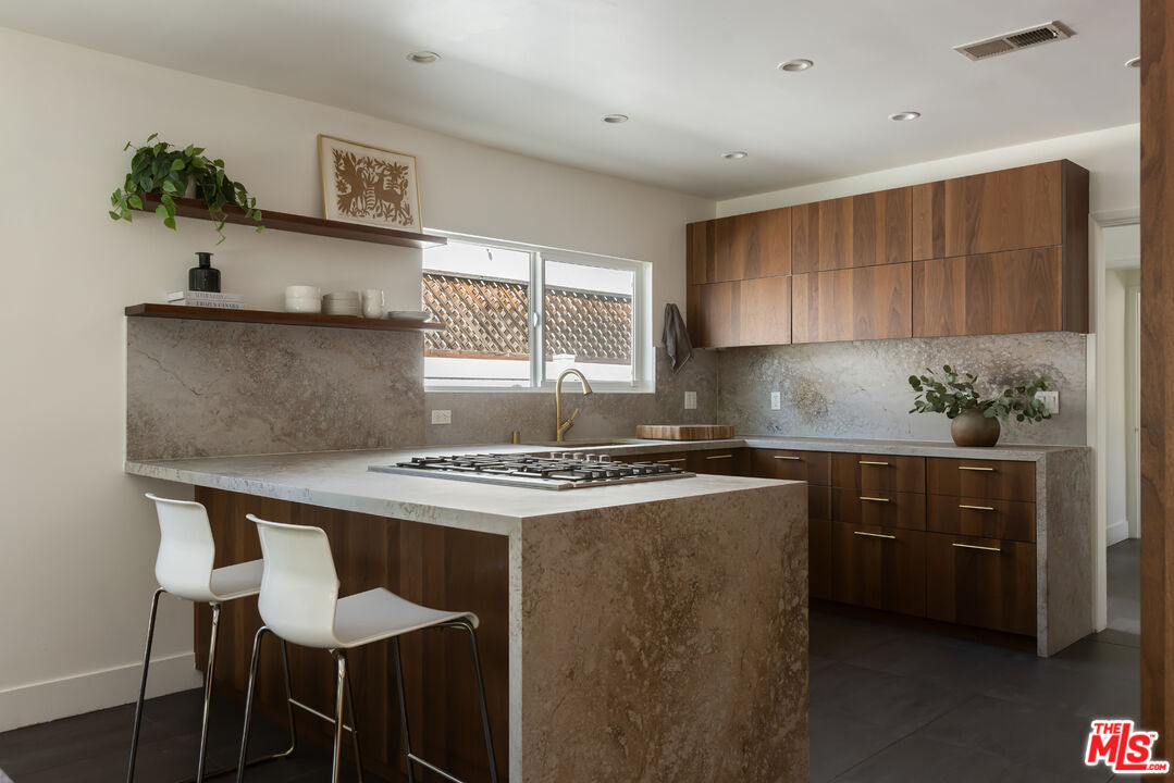 5719 Rhodes Avenue Valley Village, CA 91607 - Photo 16 of 55 a kitchen with stainless steel appliances a stove a sink and a refrigerator