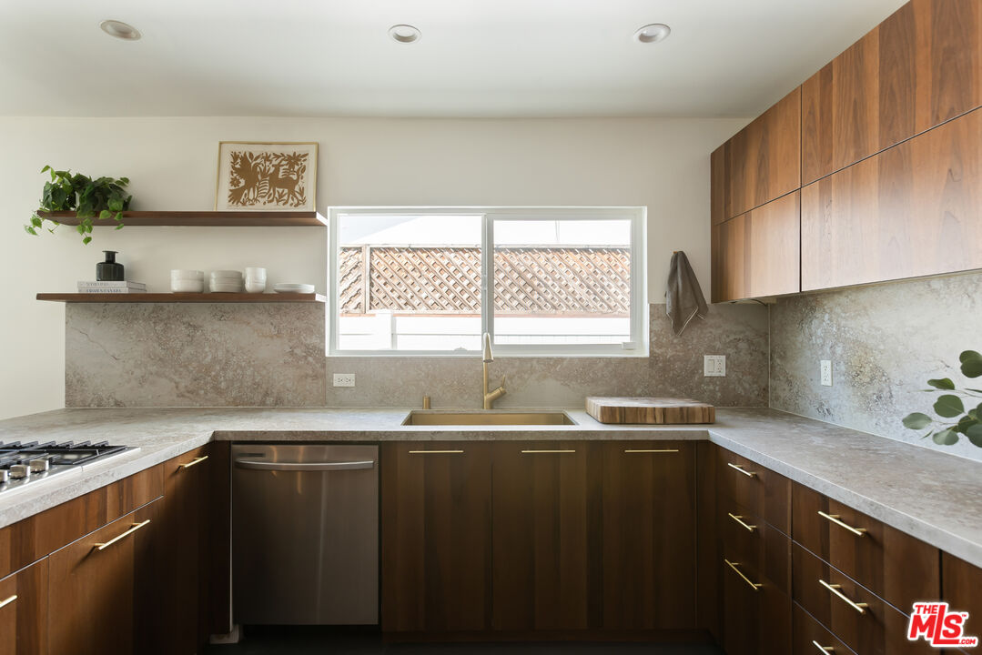 5719 Rhodes Avenue Valley Village, CA 91607 - Photo 17 of 55 a kitchen with granite countertop a sink a window and stainless steel appliances