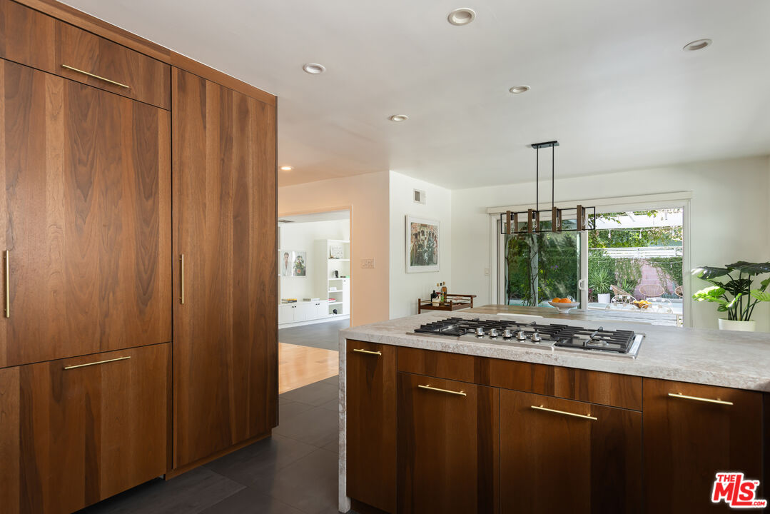 5719 Rhodes Avenue Valley Village, CA 91607 - Photo 20 of 55 a kitchen with stainless steel appliances granite countertop a refrigerator a sink dishwasher and wooden cabinets with large window