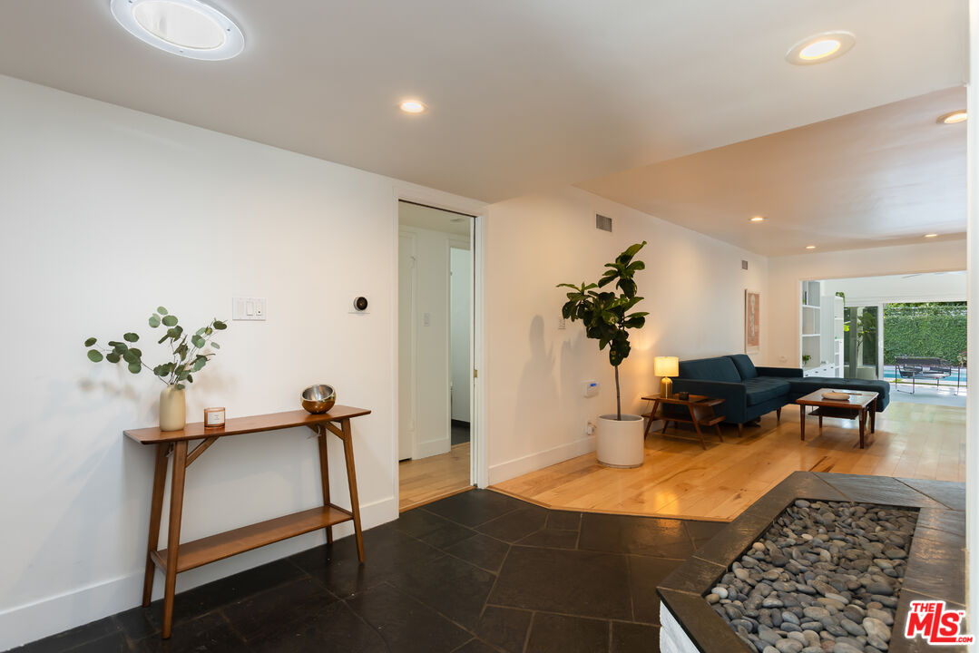 5719 Rhodes Avenue Valley Village, CA 91607 - Photo 32 of 55 a living room with furniture gym equipment and a chandelier