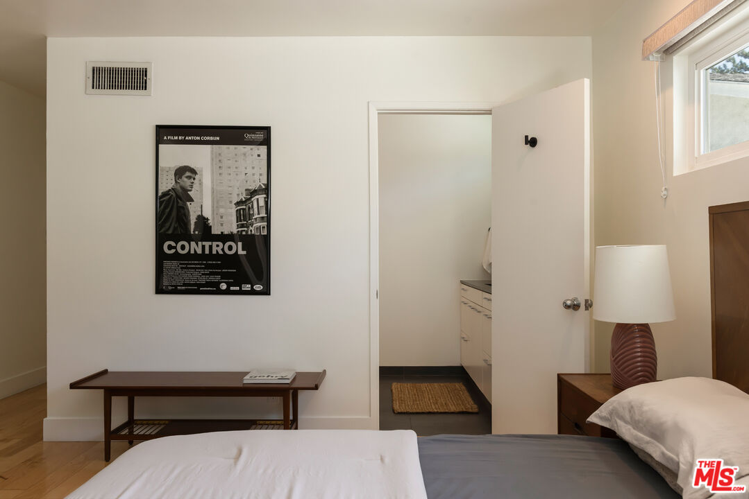 5719 Rhodes Avenue Valley Village, CA 91607 - Photo 36 of 55 a bedroom with a bed and a lamp on table