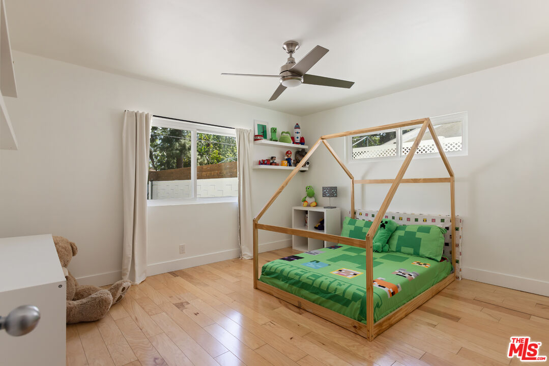 5719 Rhodes Avenue Valley Village, CA 91607 - Photo 39 of 55 a bedroom with bed and a wooden floor