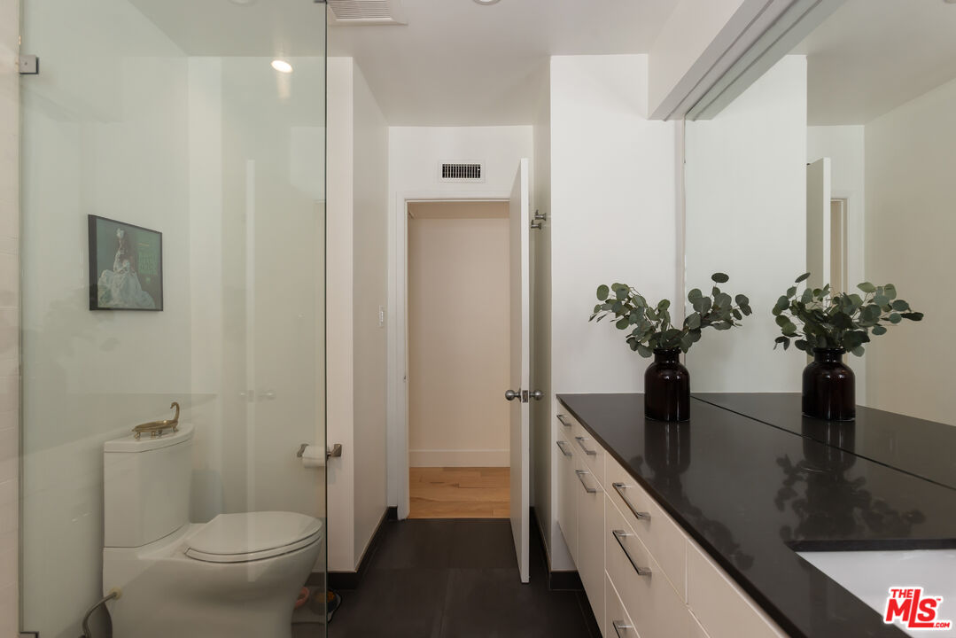 5719 Rhodes Avenue Valley Village, CA 91607 - Photo 41 of 55 a view of a hallway with wooden floor and a potted plant