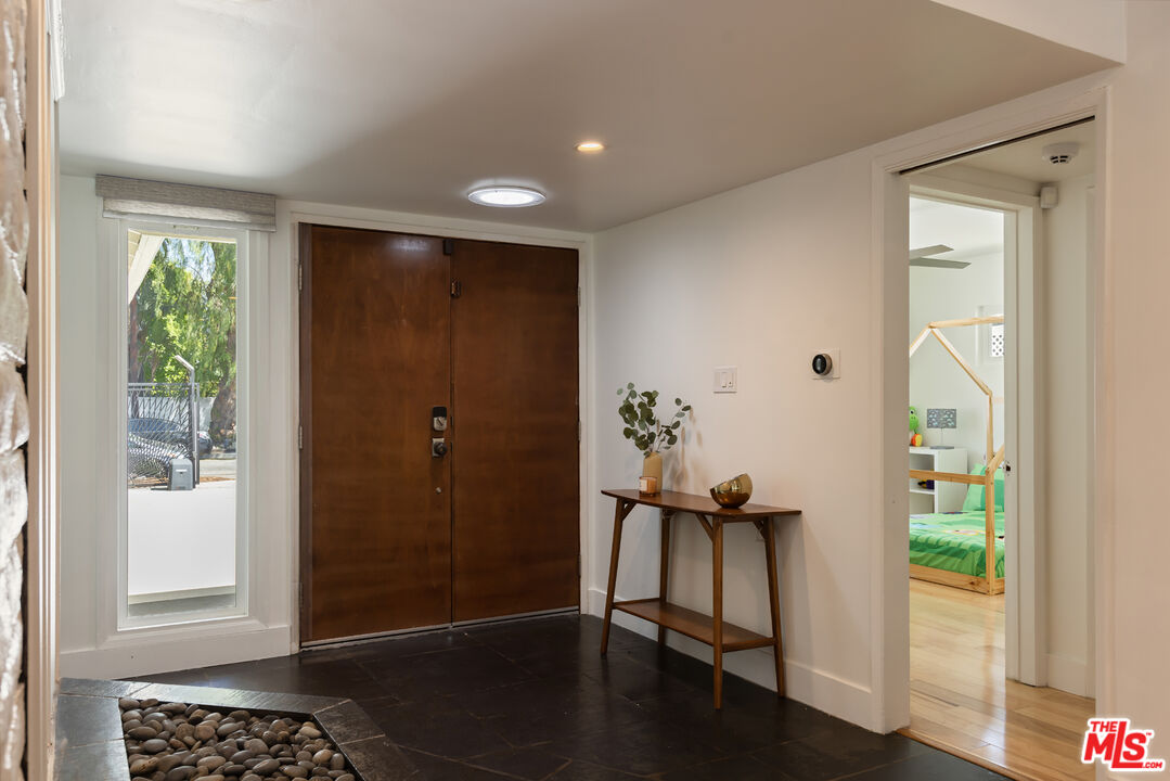 5719 Rhodes Avenue Valley Village, CA 91607 - Photo 43 of 55 a view of a hallway with wooden floor and a livingroom