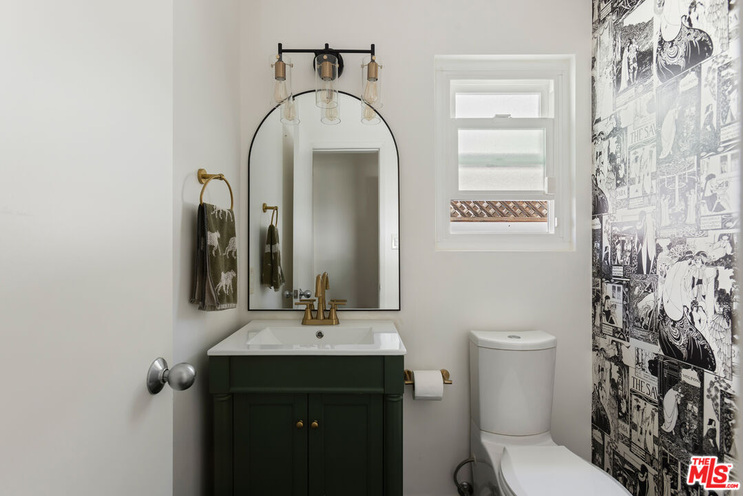 5719 Rhodes Avenue Valley Village, CA 91607 - Photo 47 of 55 a bathroom with a toilet sink and mirror