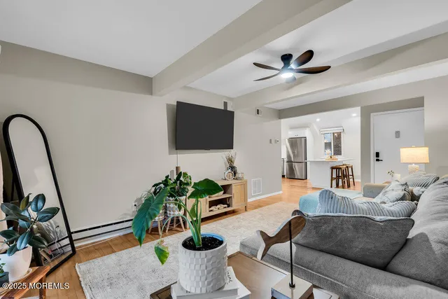 a kitchen with refrigerator cabinets and wooden floor