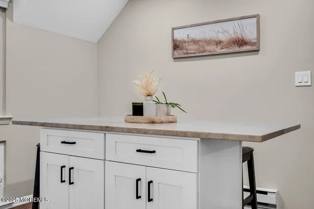 a spacious bedroom with a large bed and a dresser