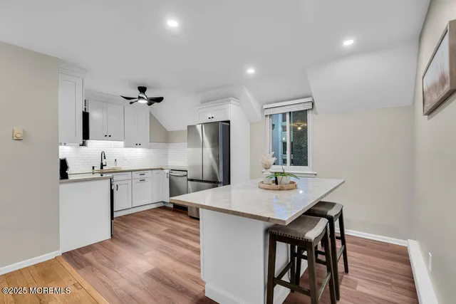 a kitchen with stainless steel appliances a stove microwave and cabinets