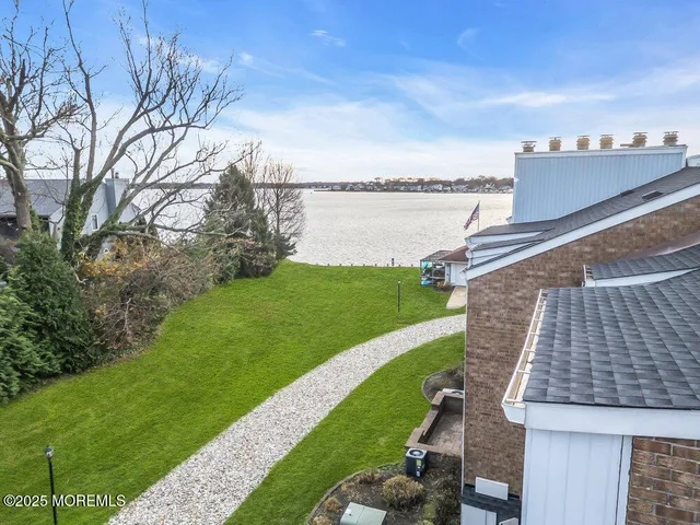 a view of a river and garden with seating area