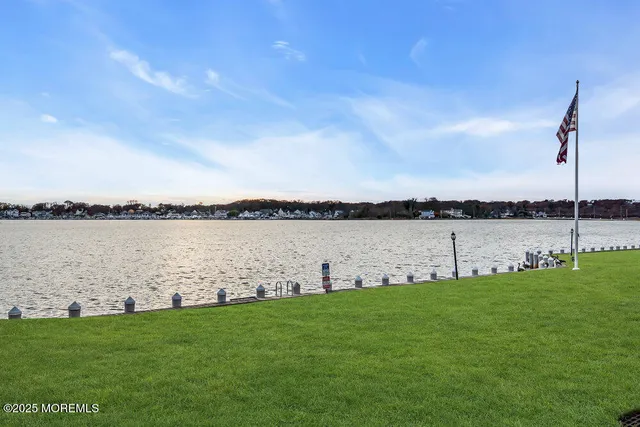 an aerial view of a house with outdoor space and lake view