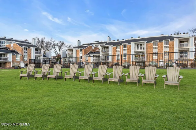an aerial view of a house with a garden and lake view