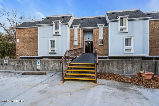 a view of hallway with furniture and wooden floor