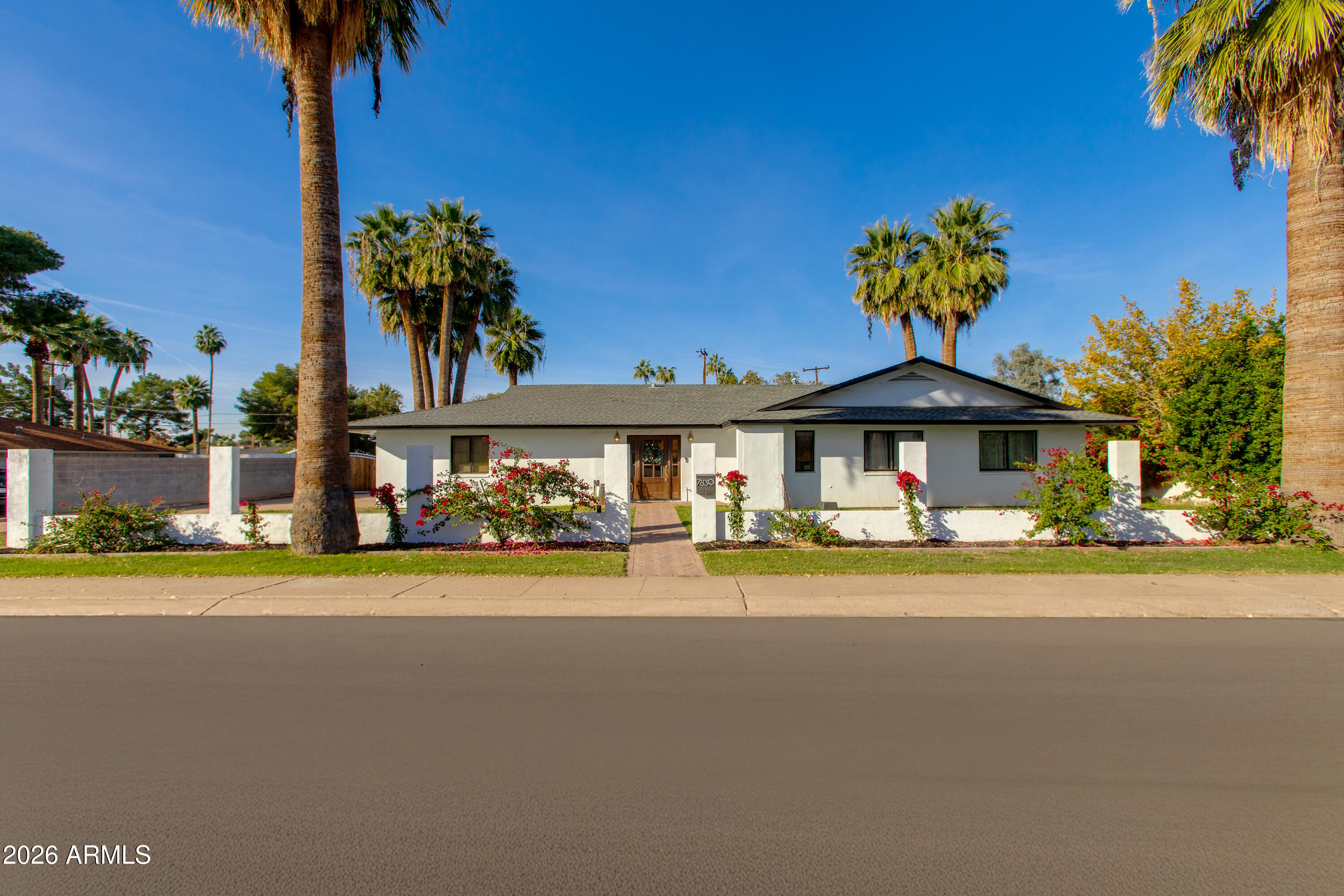 a front view of a house with a garden and porch
