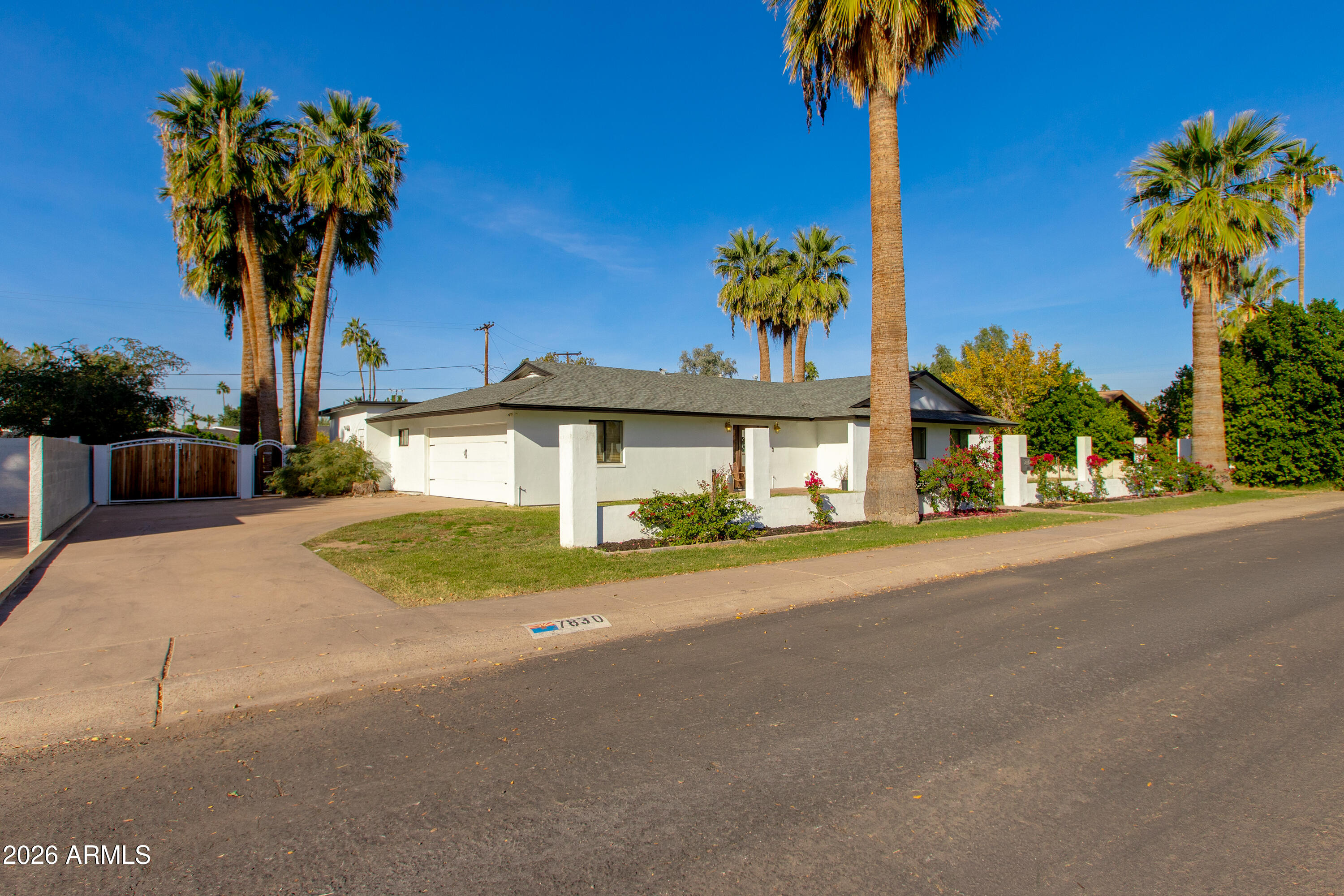 7830 North 7th Avenue Phoenix, AZ 85021 - Photo 2 of 43 a front view of a house with a yard and a garage