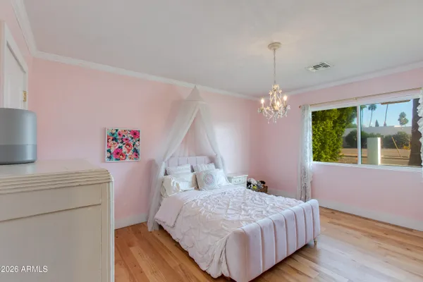 a bedroom with a bed dresser and a window