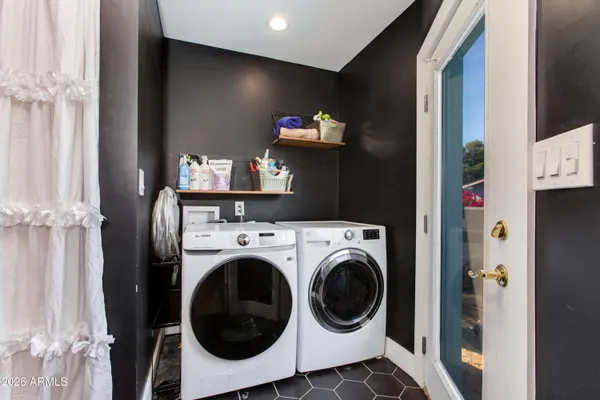 a kitchen with stainless steel appliances kitchen island granite countertop a refrigerator and a stove top oven