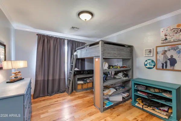 a workspace with wooden floor and bedroom view