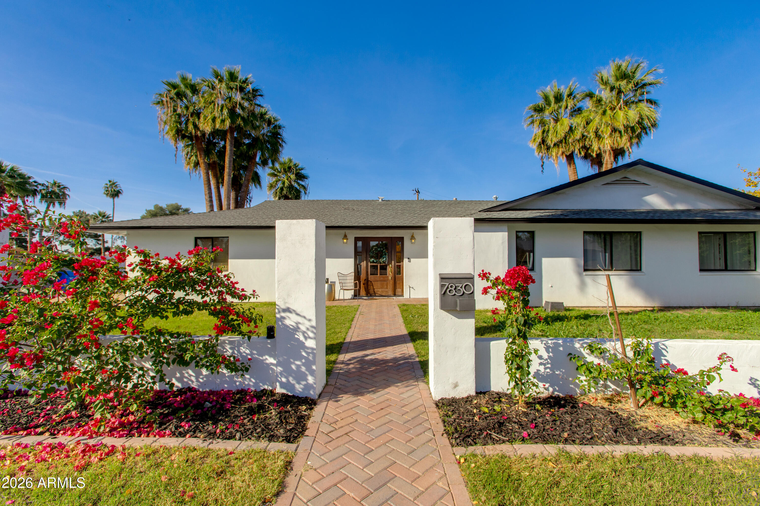 7830 North 7th Avenue Phoenix, AZ 85021 - Photo 3 of 43 a front view of a house with a yard