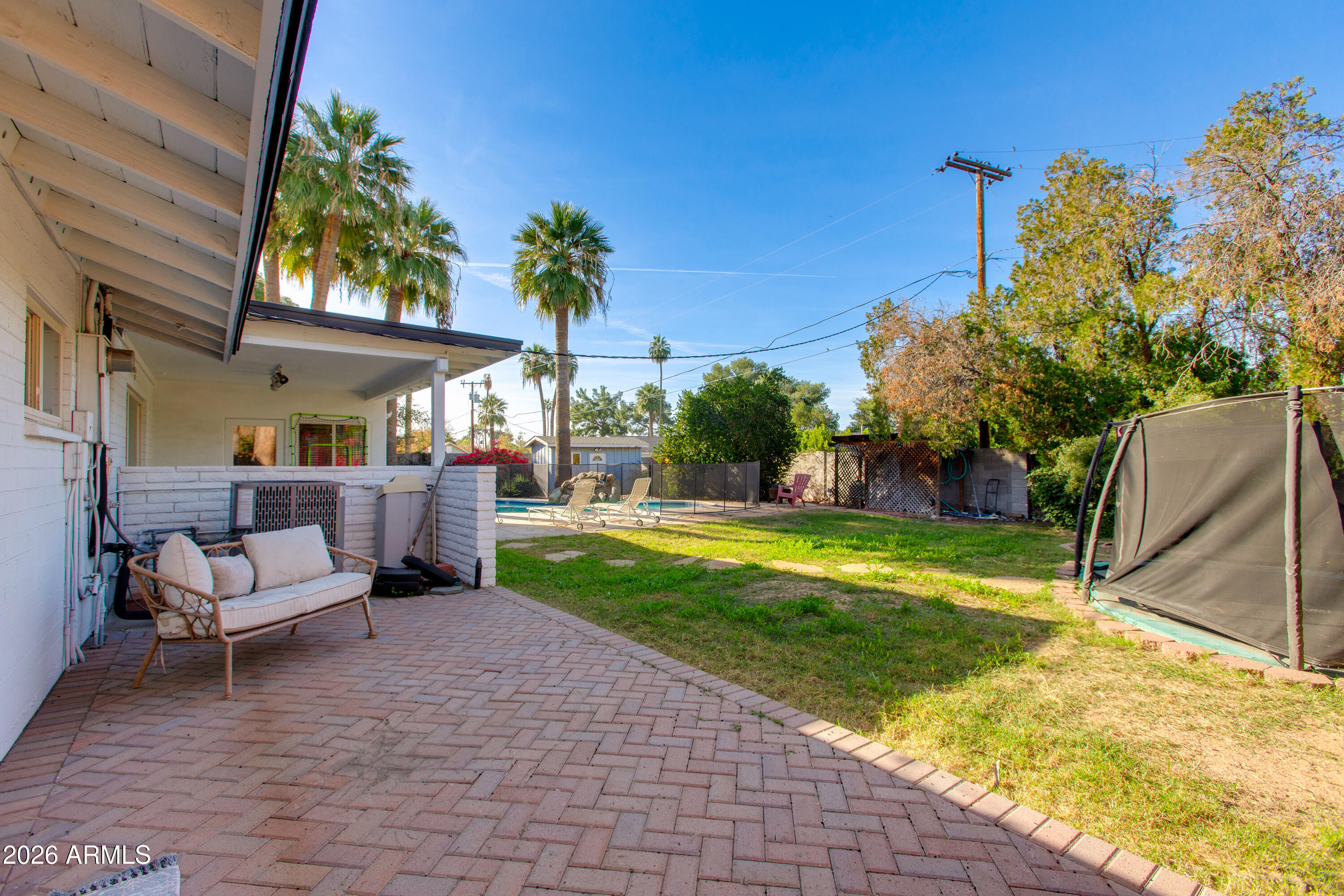 7830 North 7th Avenue Phoenix, AZ 85021 - Photo 31 of 43 a swimming pool with outdoor seating and yard