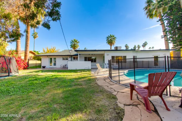 a view of a house with backyard porch and sitting area