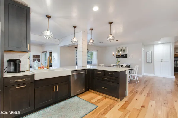 a kitchen with cabinets and wooden floor