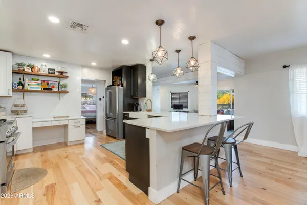 a large kitchen with a table and chairs