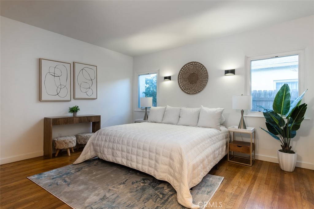 254 South Berkeley Avenue Pasadena, CA 91107 - Photo 13 of 40 a bedroom with a bed lamp and a potted plant