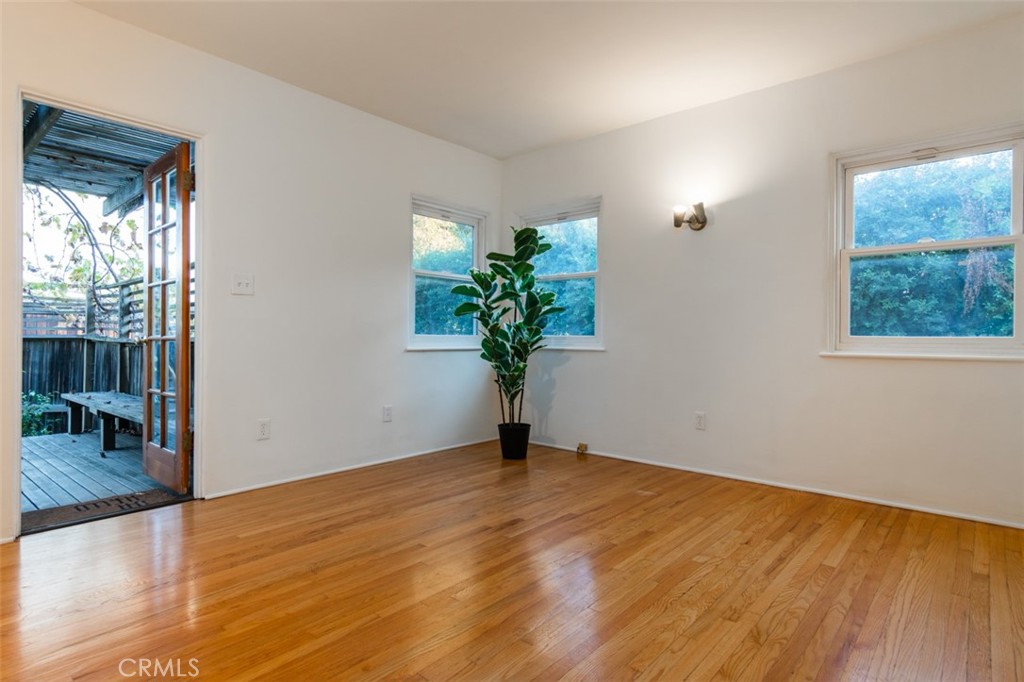 254 South Berkeley Avenue Pasadena, CA 91107 - Photo 17 of 40 a view of an empty room with wooden floor and a window