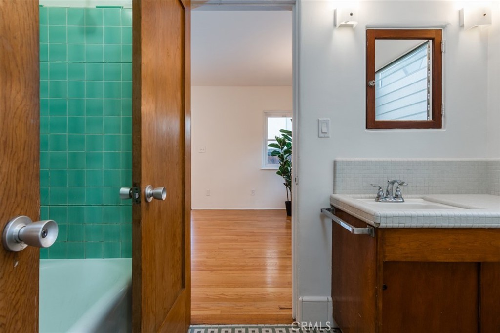 254 South Berkeley Avenue Pasadena, CA 91107 - Photo 22 of 40 a bathroom with a granite countertop sink a mirror and shower