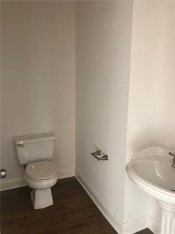a white toilet sitting next to a sink