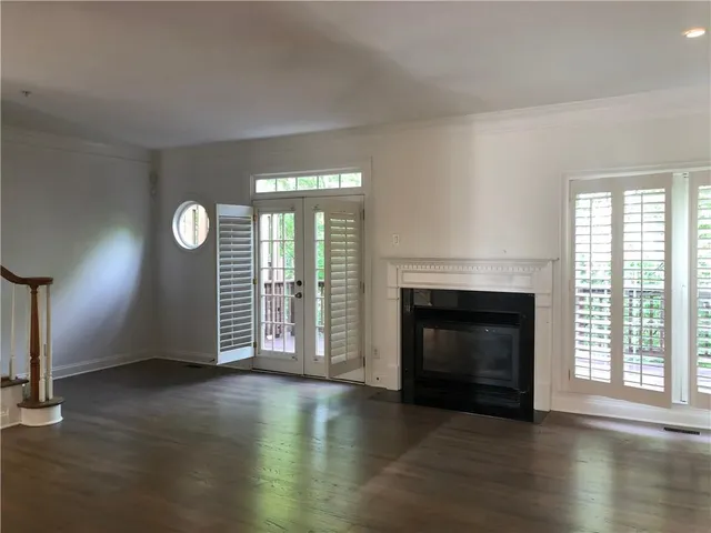 wooden floor fireplace and natural light in room