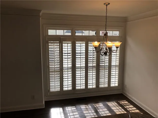 a view of room with window and chandelier
