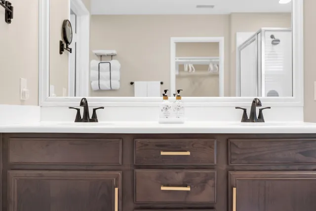 a bathroom with a sink a toilet and shower