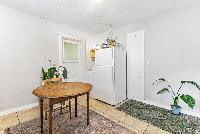 232 300 North Provo, UT 84606 - Photo 8 of 27 Dining space with washer / clothes dryer, light tile patterned floors, and a textured ceiling
