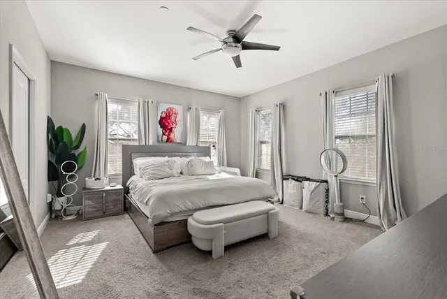 a spacious bedroom with a bed and a chandelier