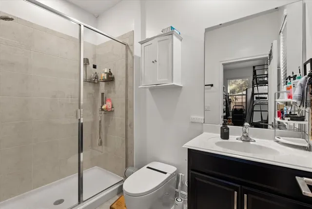 a bathroom with a sink toilet and shower