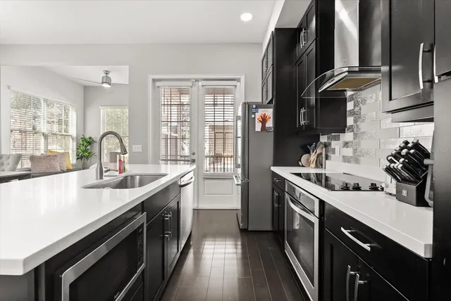 a kitchen with a sink stove and cabinets