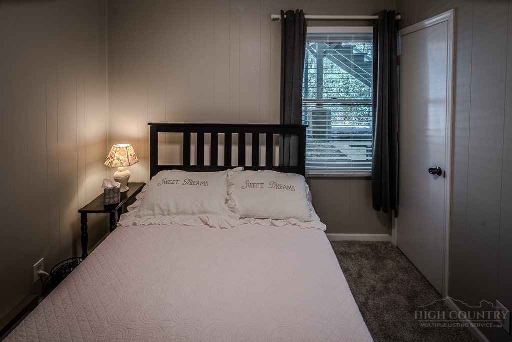 38 Rocky Meadows Road Newland, NC 28657 - Photo 27 of 50 a bed sitting in a bedroom next to a window