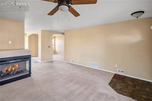 an empty room with windows and entrance