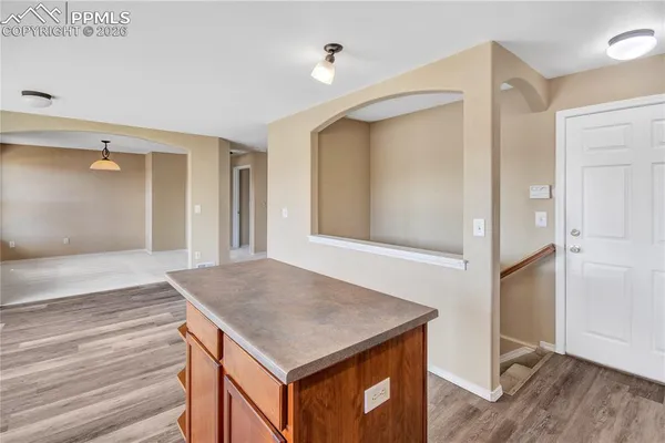 an empty room with windows and ceiling fan