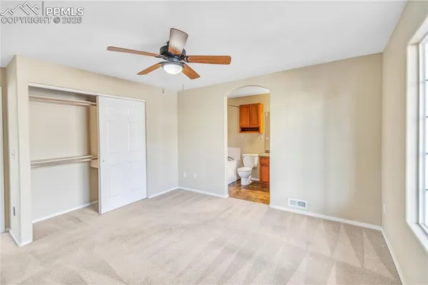 a white toilet sitting next to a bath tub